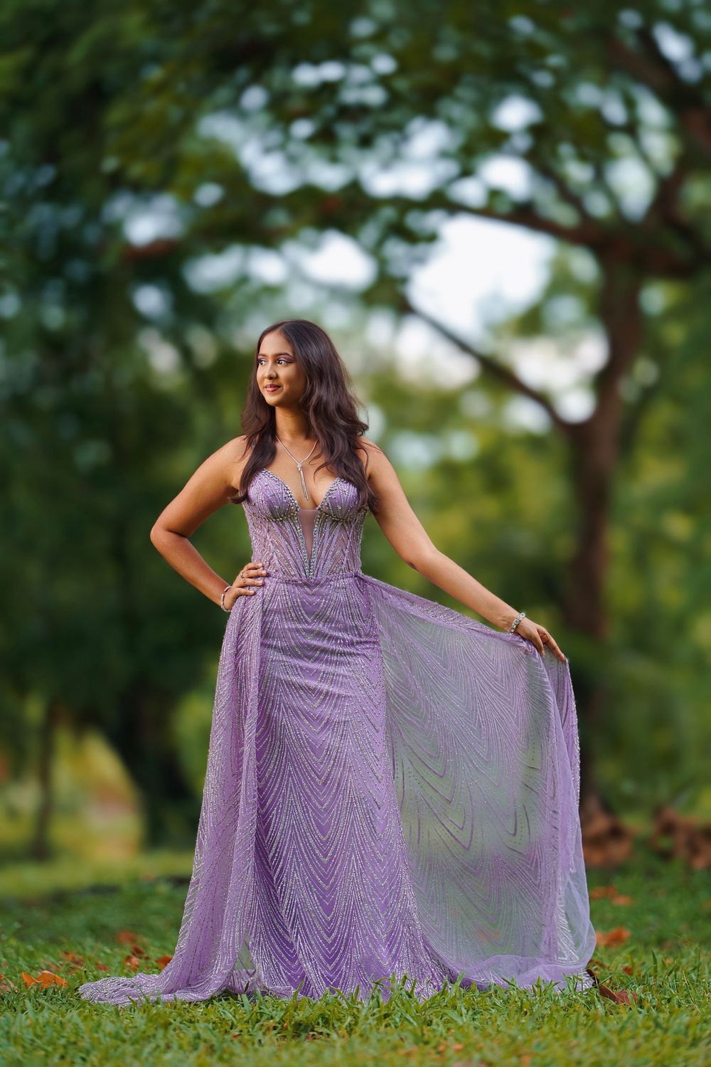 Flowing lilac gown with sweetheart neckline captured in a dreamy garden setting at golden hour.