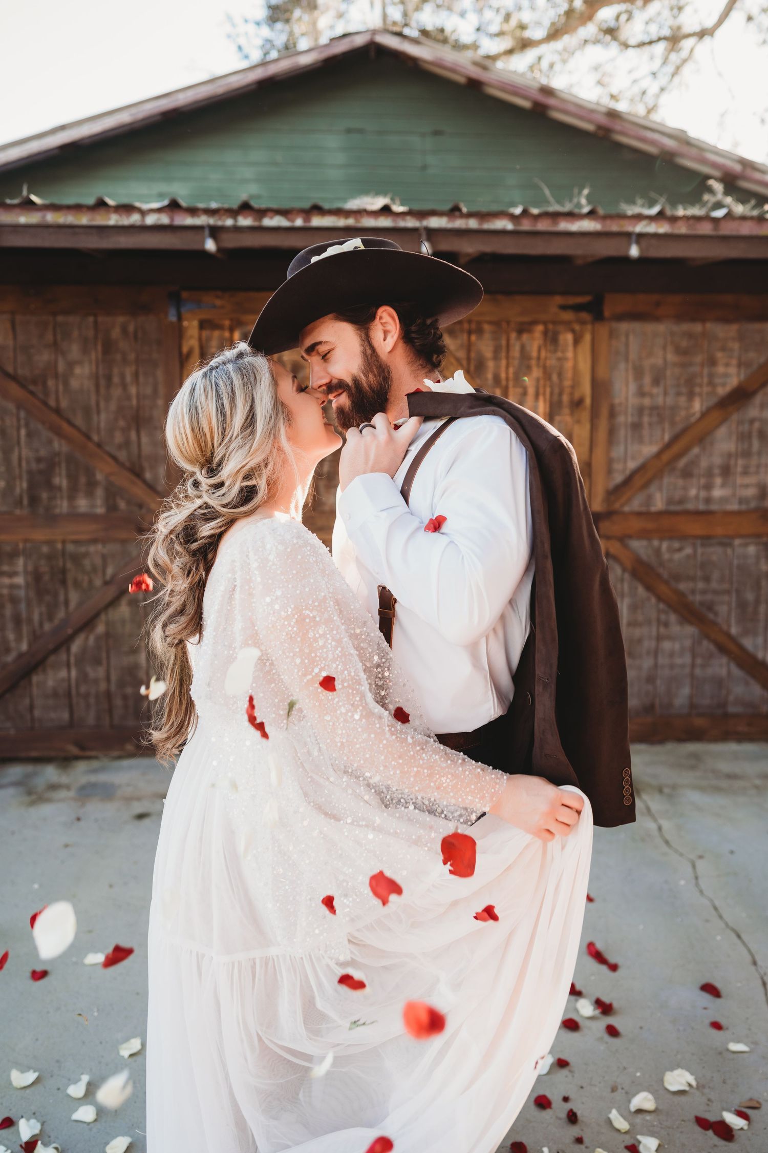 Newlyweds embracing with rose petals falling in warm afternoon sun in Wesley Chapel Florida