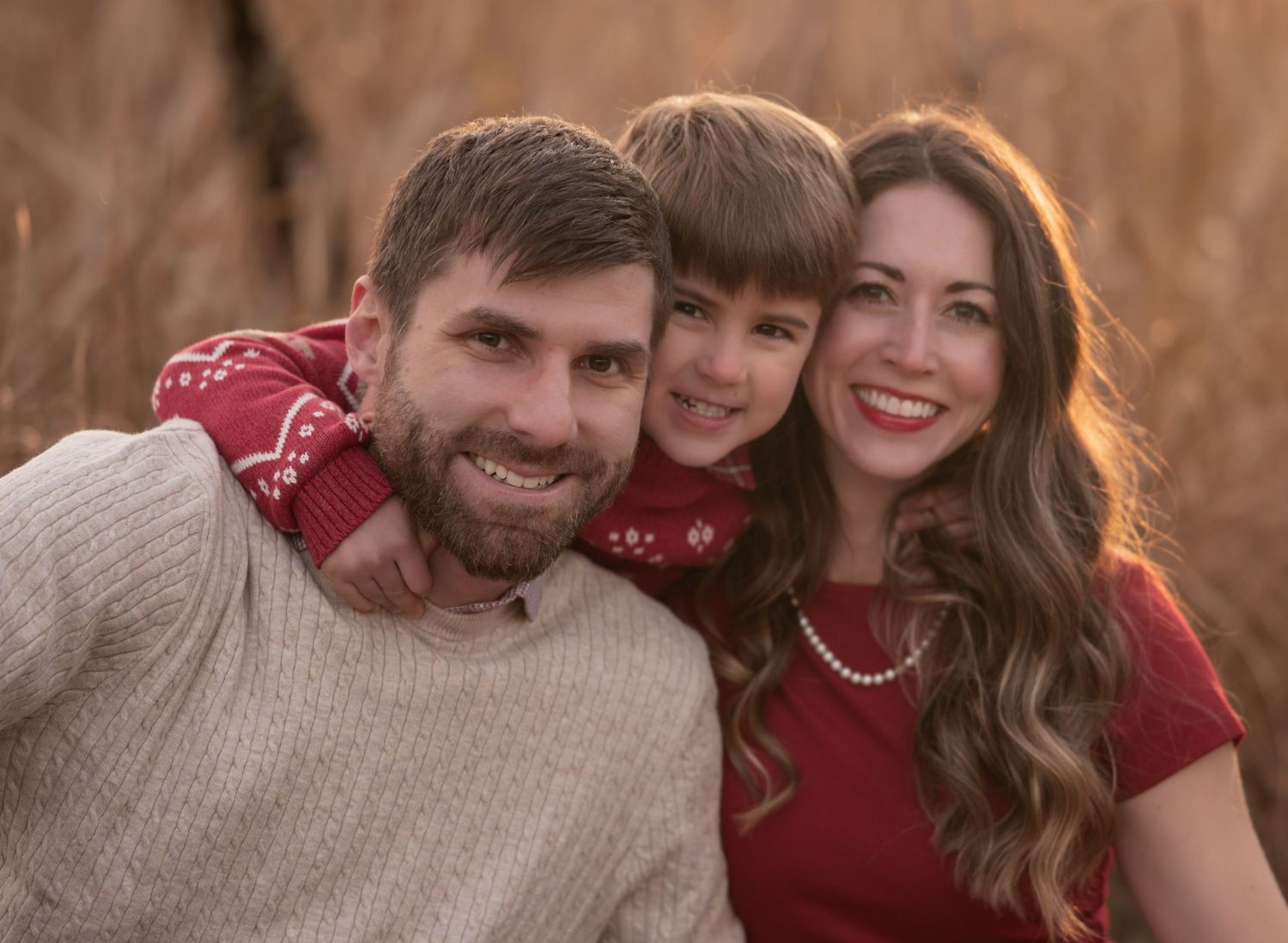 A series of candid outdoor photo booth style shots showing people in red and beige sweaters posing together.