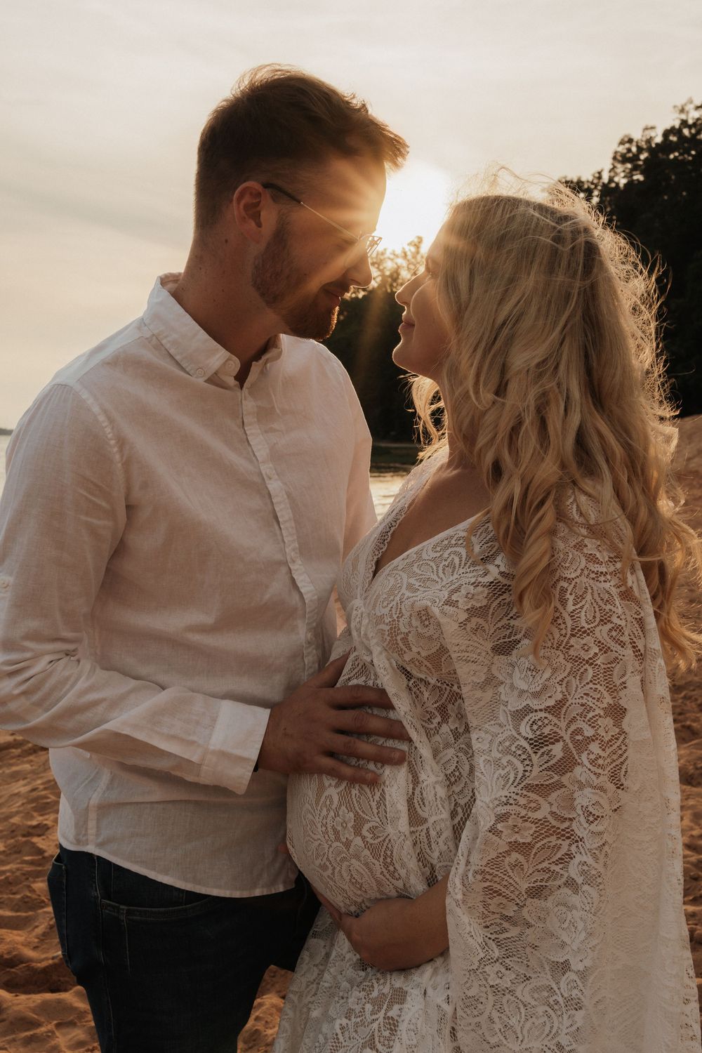 A couple in wedding attire shares intimate moments on a beach at sunset in a series of romantic photographs.