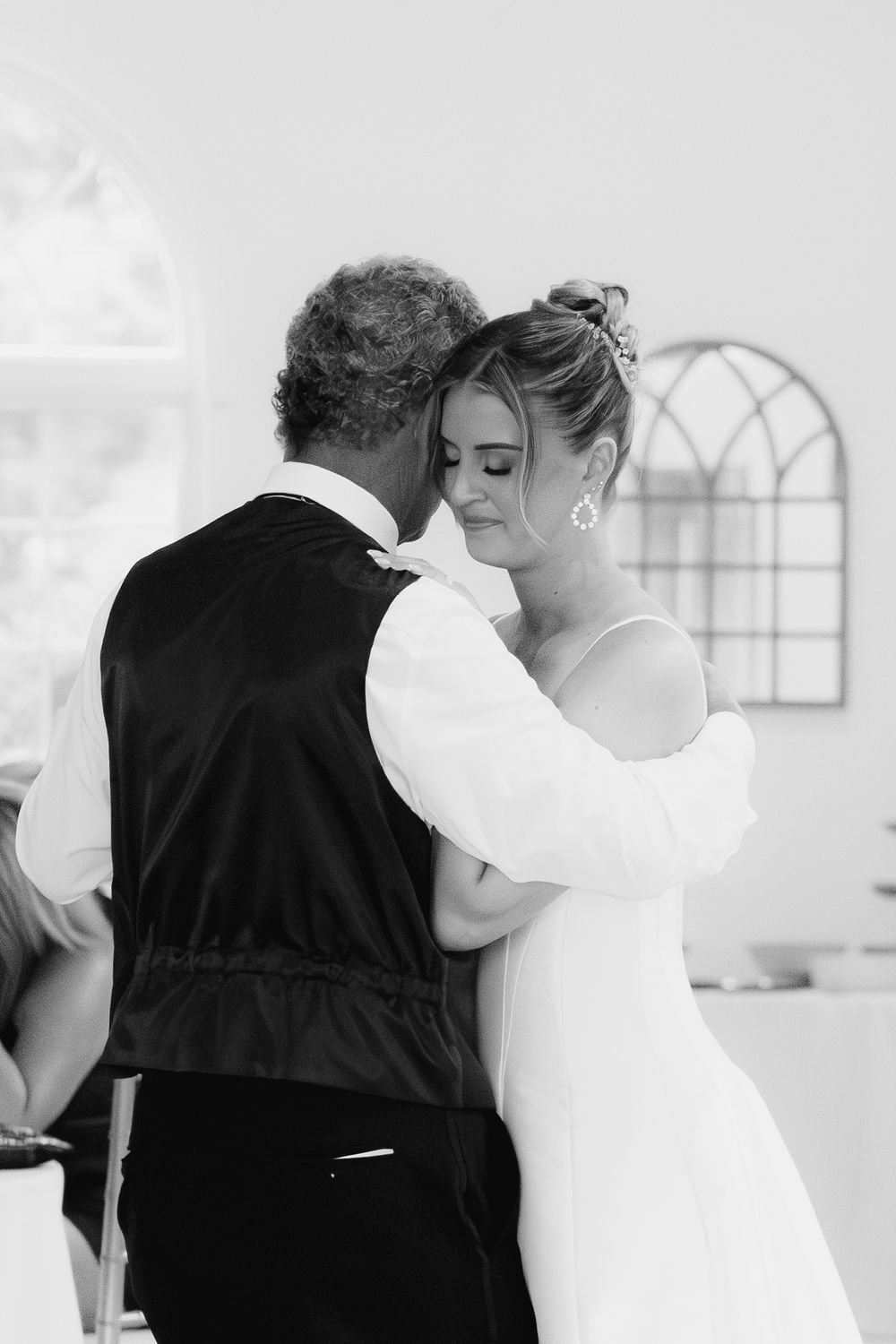 Black and white wedding photos showing intimate moments during a formal dance.