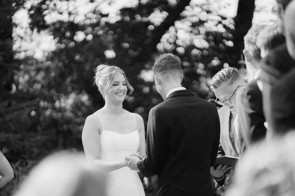 Black and white candid wedding ceremony photos showing joyful moments.