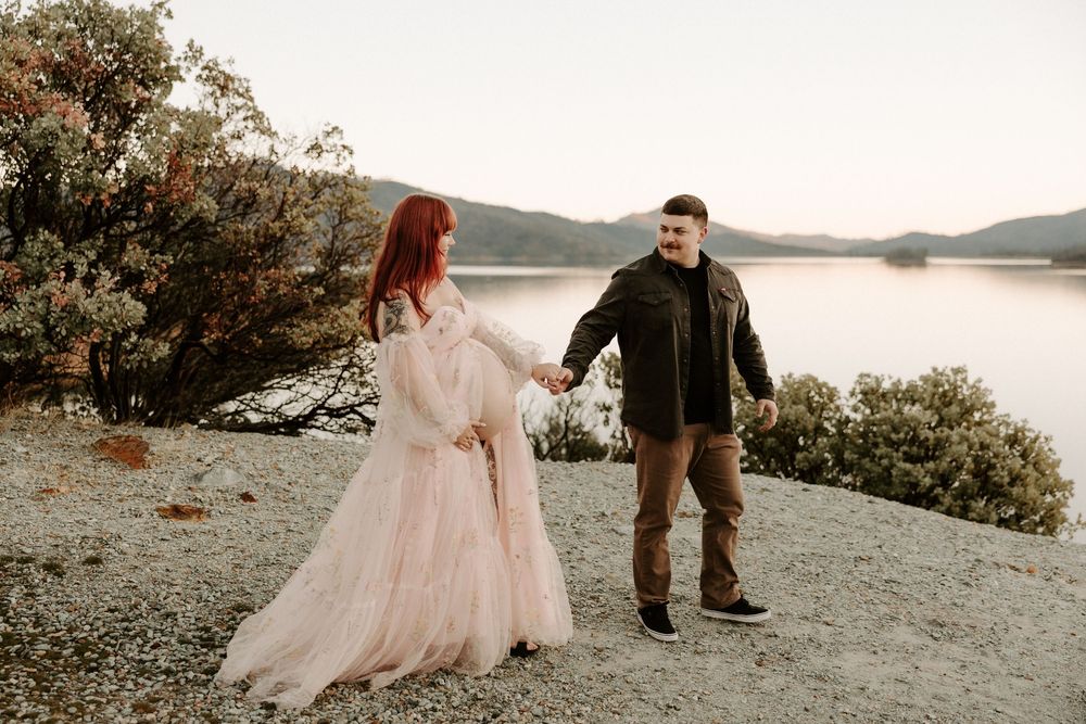 Couple in romantic poses on a scenic mountain overlook during sunset in the Pacific Northwest.