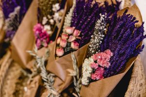 Dried purple lavender and pink flower arrangements on display.