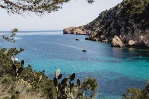 Mediterranean coastline with crystal clear turquoise waters and rocky cliffs.