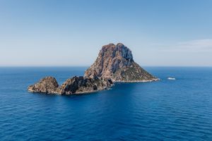 Dramatic rock formations rising from deep blue Mediterranean waters.