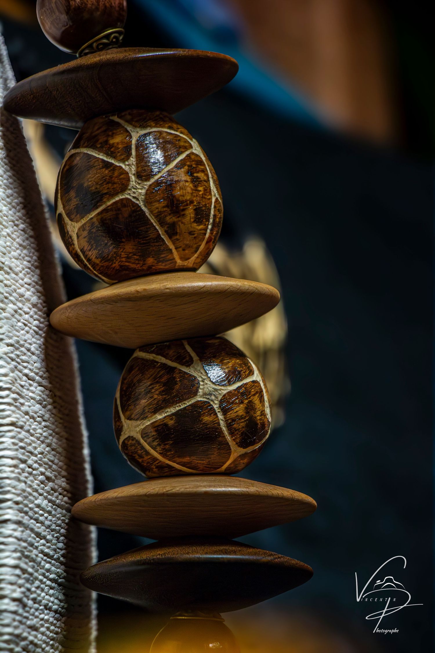Artistic macro shots of stacked wooden or stone objects with intricate textures and patterns.