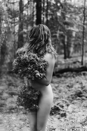 Artistic black and white forest photography featuring a nude figure adorned with natural foliage in multiple poses.