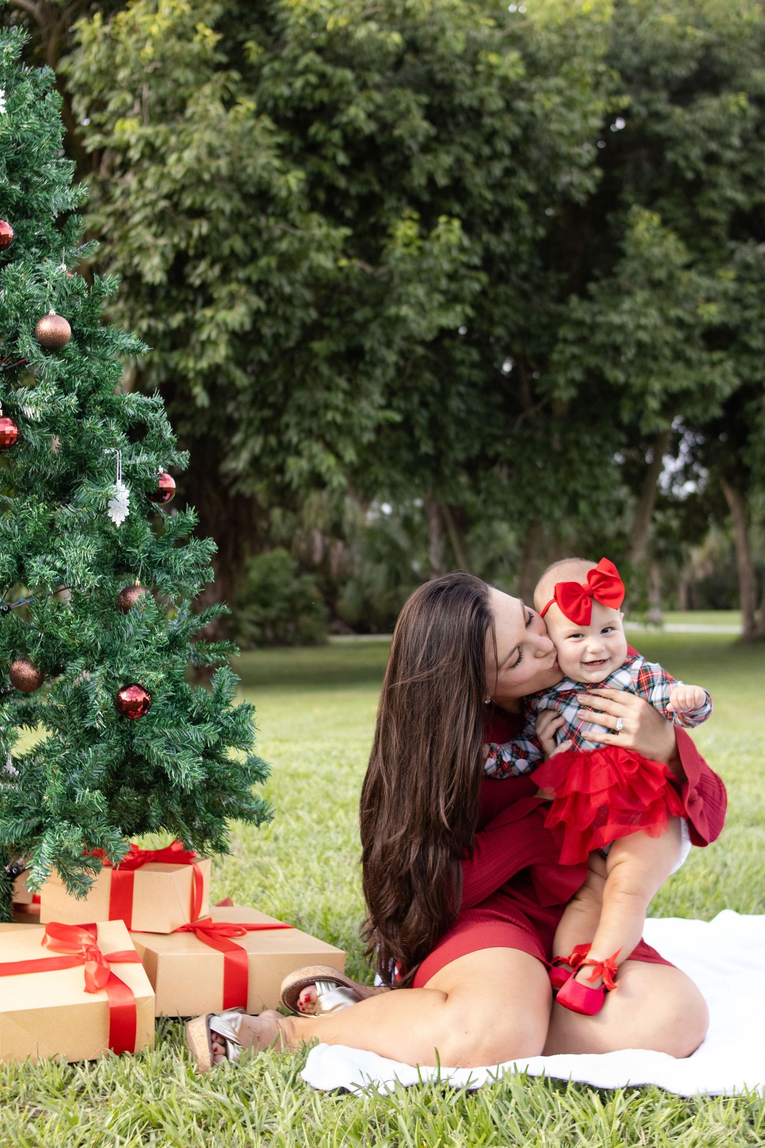 mother kissing daughter christmas photo