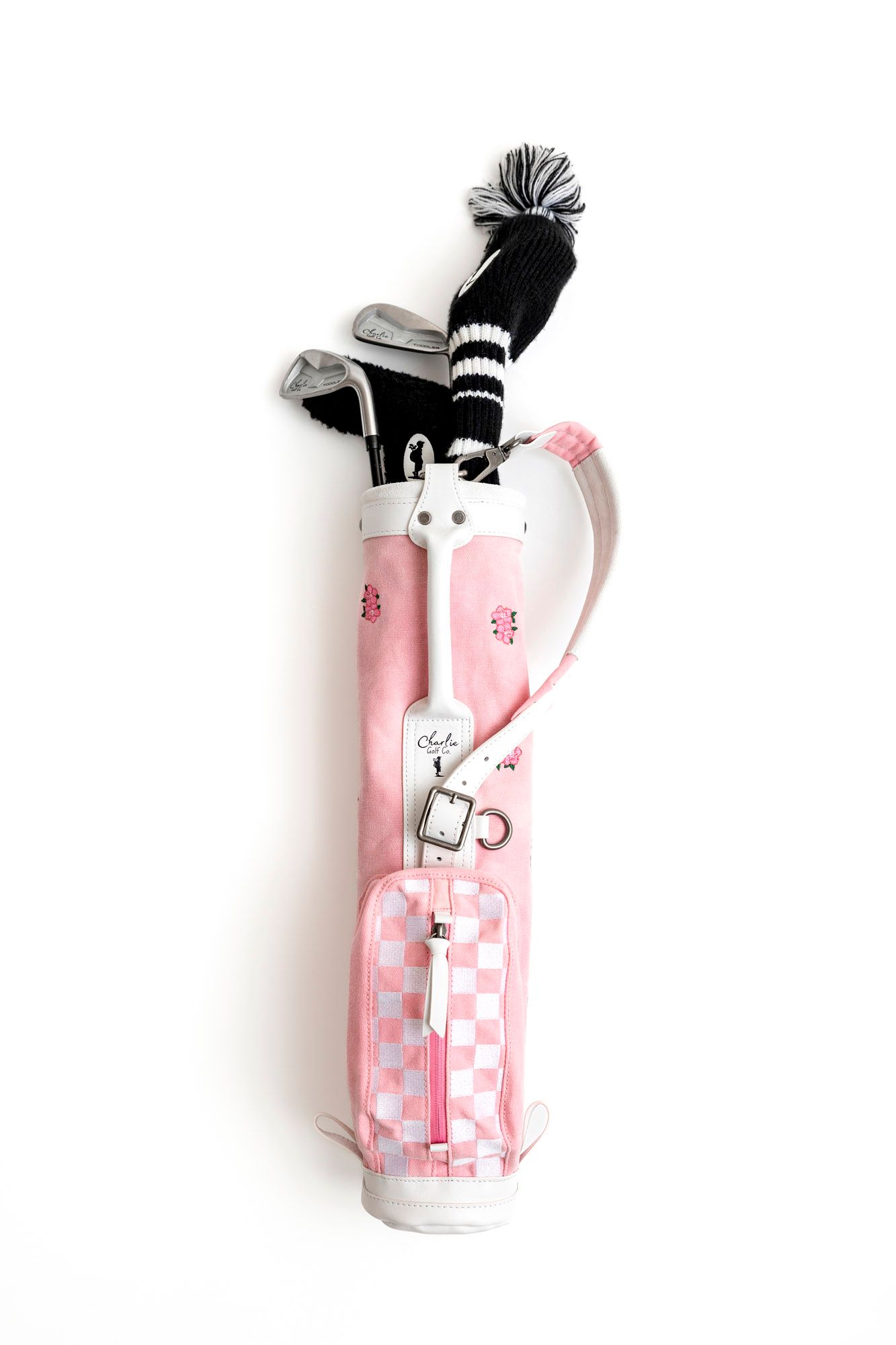 Four white cans with pink and black artistic designs arranged in a minimalist style against a white background.