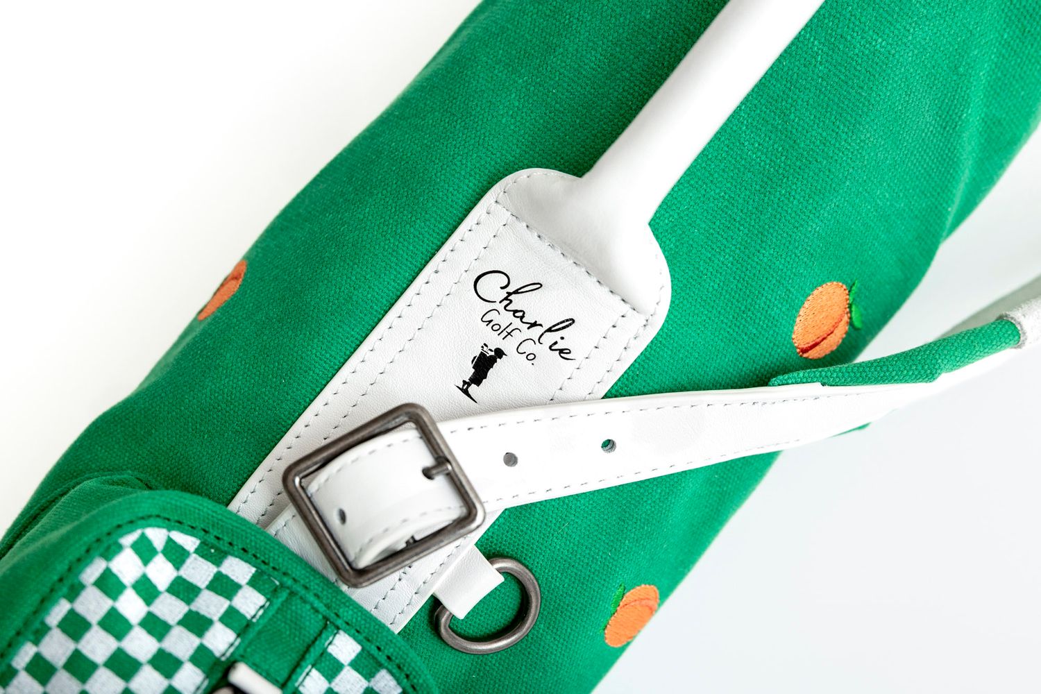Green and white checkered Vans sneakers with orange accents shown from multiple angles on a white background.