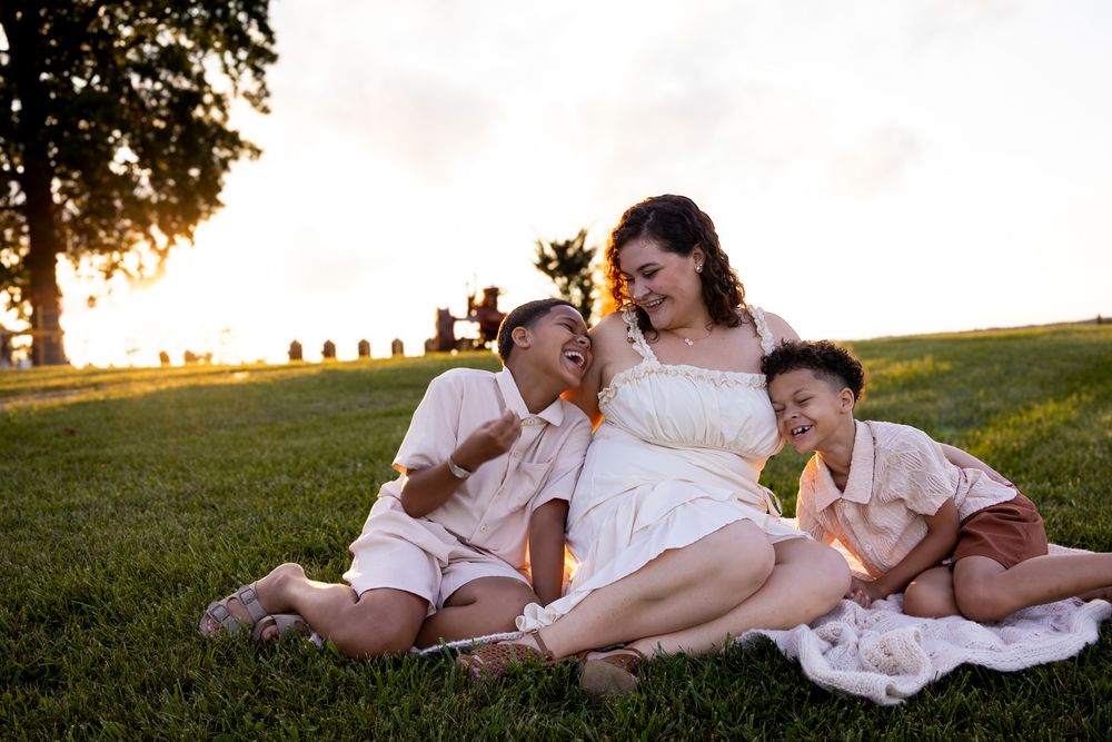 family sitting in grass