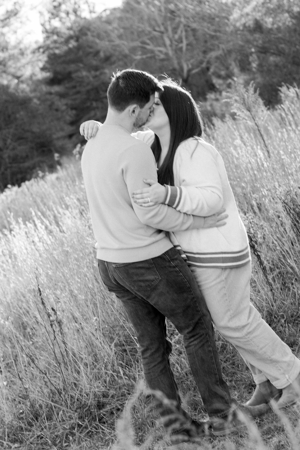 couple kissing in field