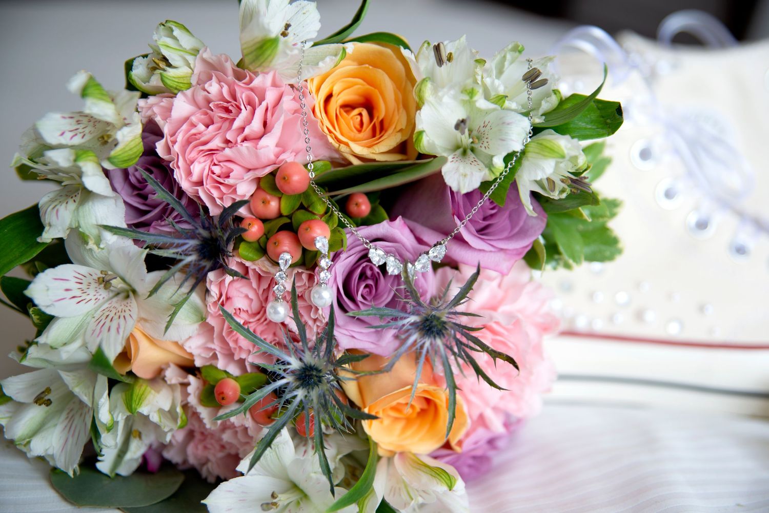 Photo of a colourful bouquet and bridal jewelry.