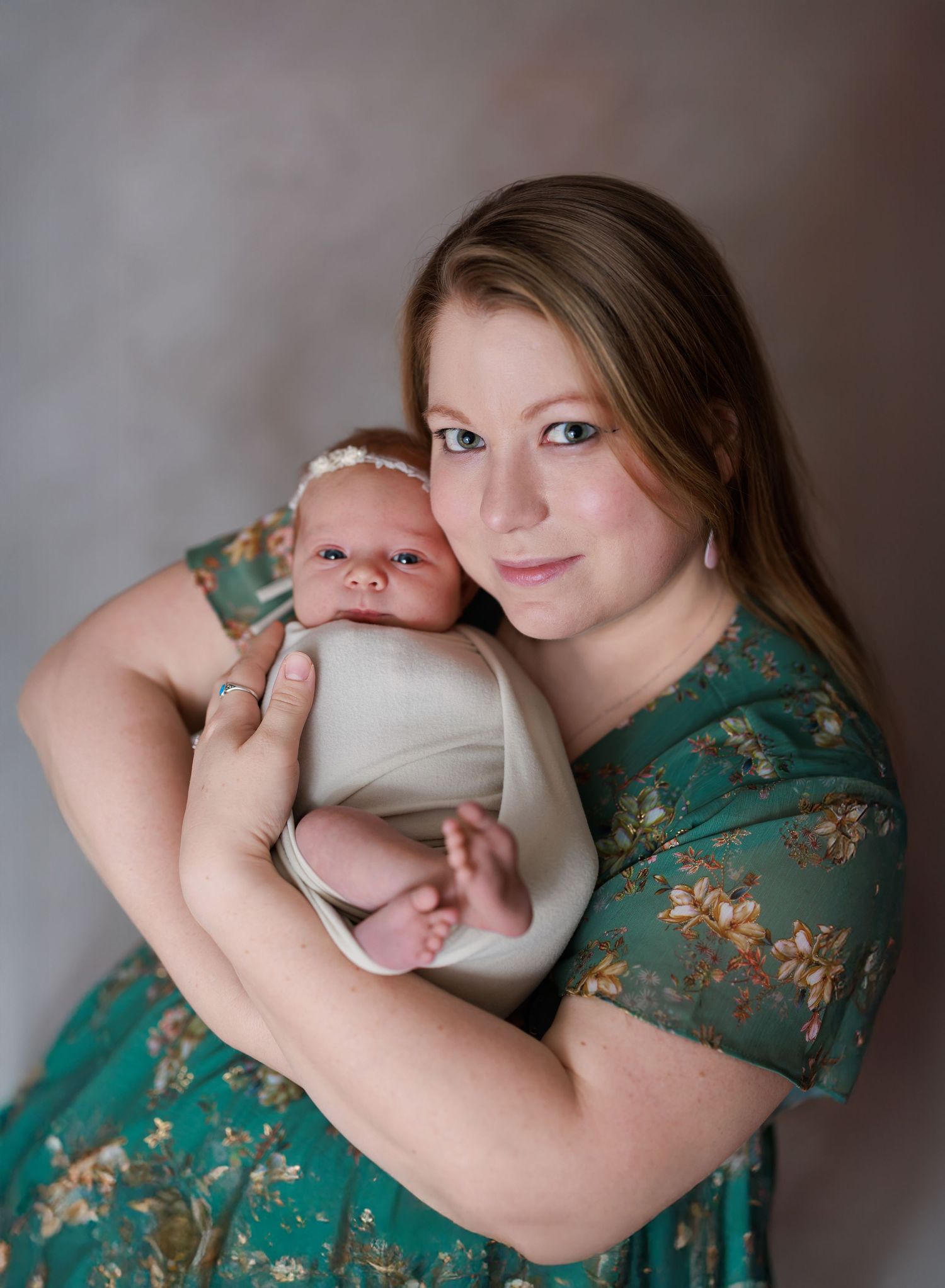 Newborn baby girl photographed with her mom
