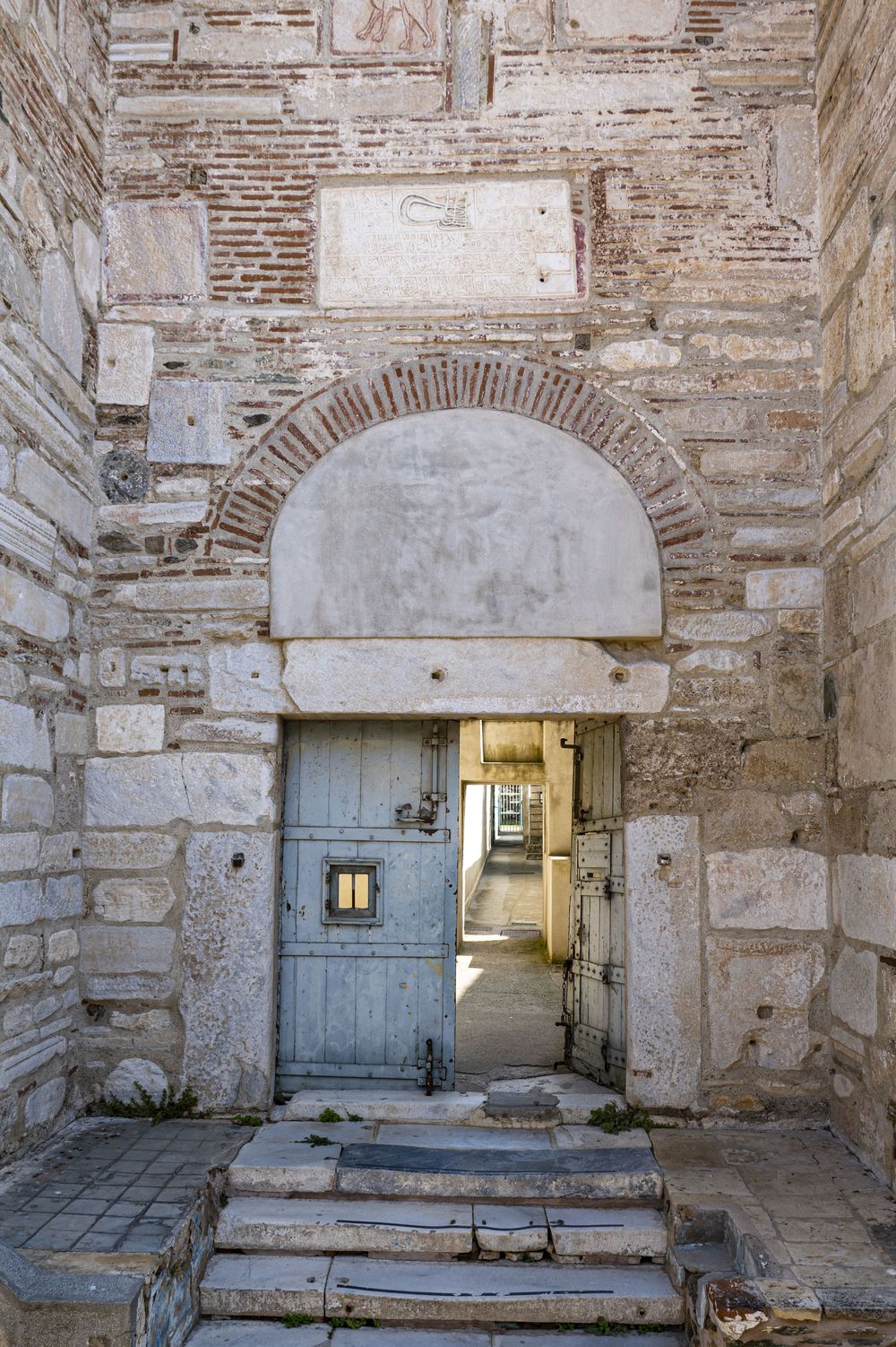 Ancient stone archways and weathered walls line a historic corridor with illuminated passages at the Diocletian's Palace in Split.