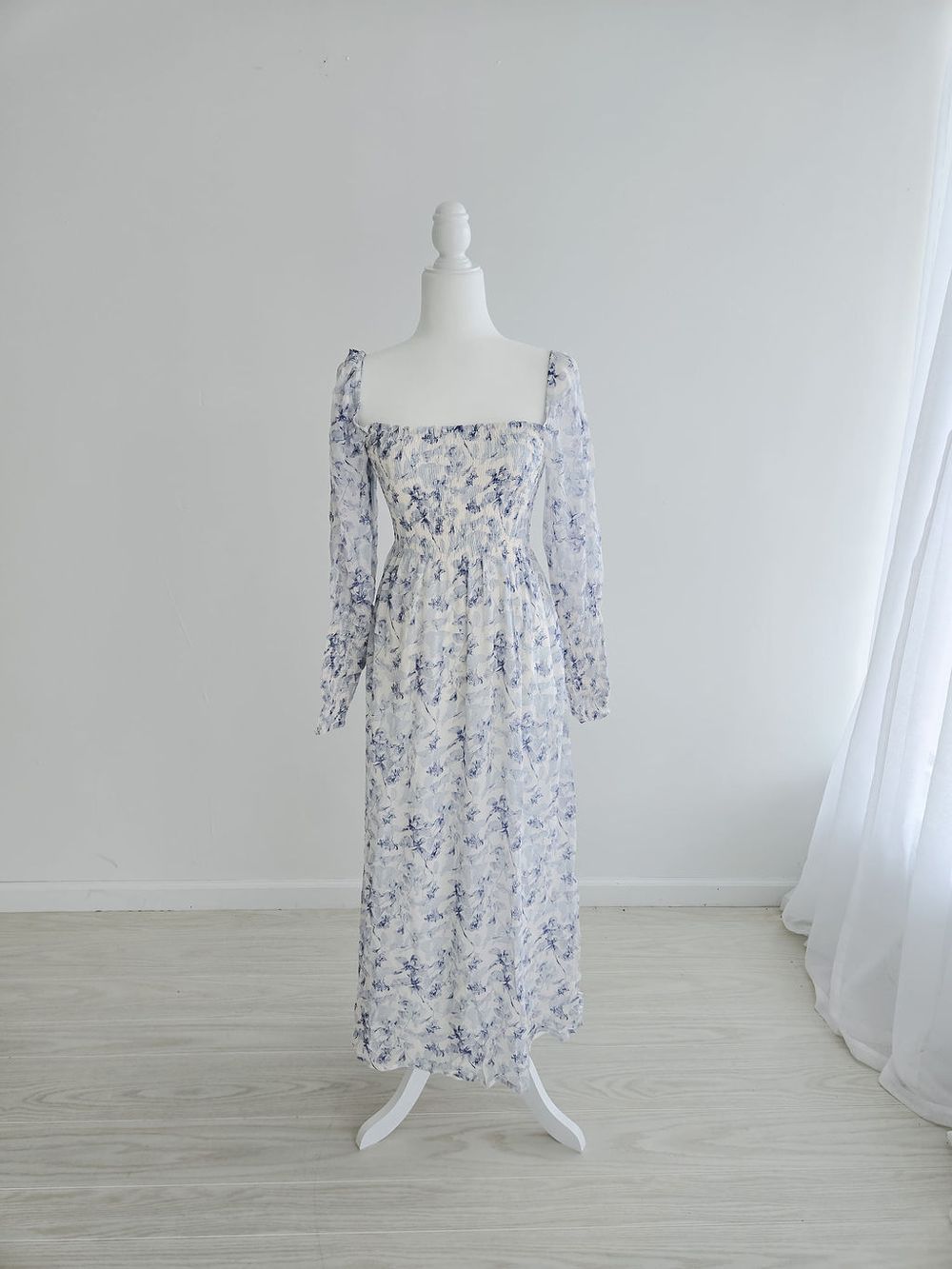 Light purple floral sundress with puff sleeves displayed on white mannequin in studio setting.
