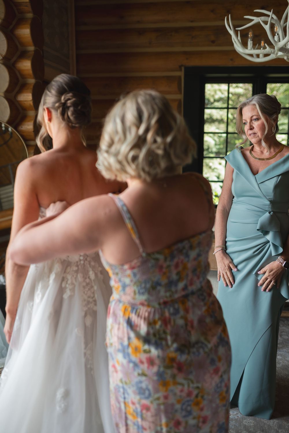 A sequence of wedding preparation photos showing a tender moment between two people in a rustic cabin setting.
