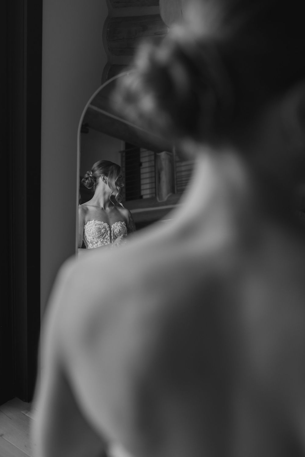 Artistic black and white photograph showing a blurred profile silhouette against a dark background.