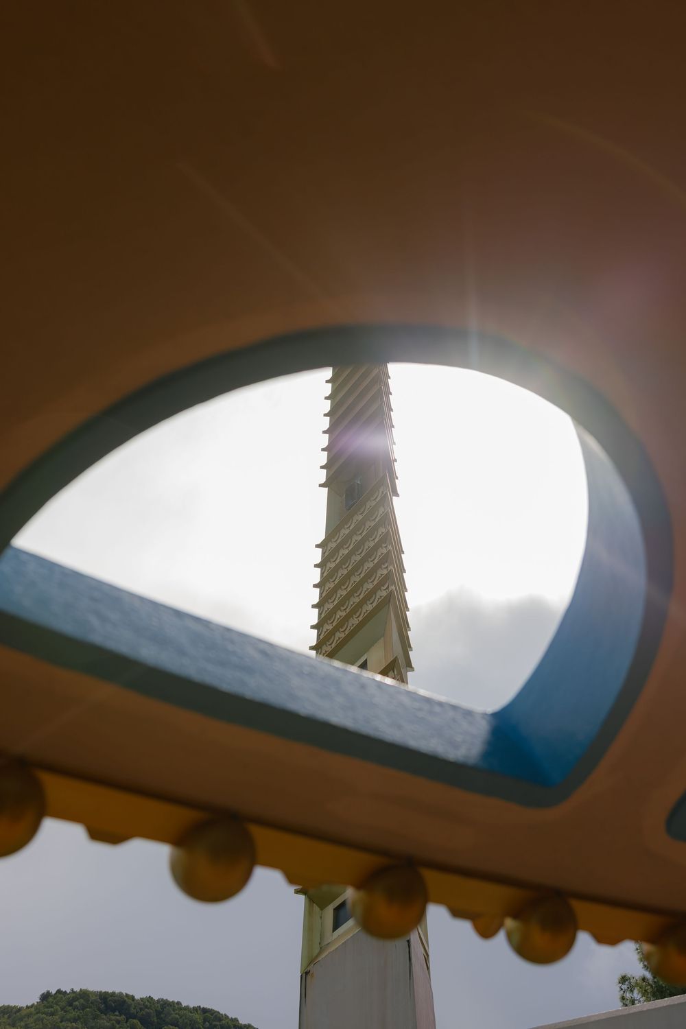 Series of architectural details showing curved archways against a bright sky.