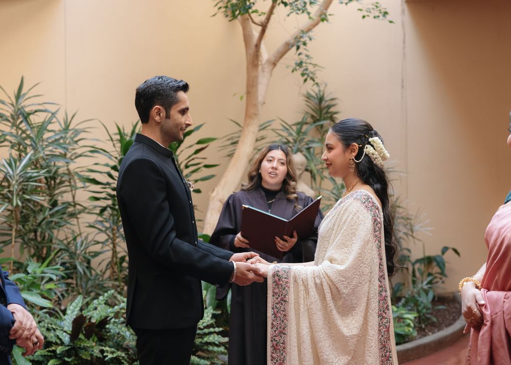 Outdoor courtyard ceremony setup with greenery and decorative elements.