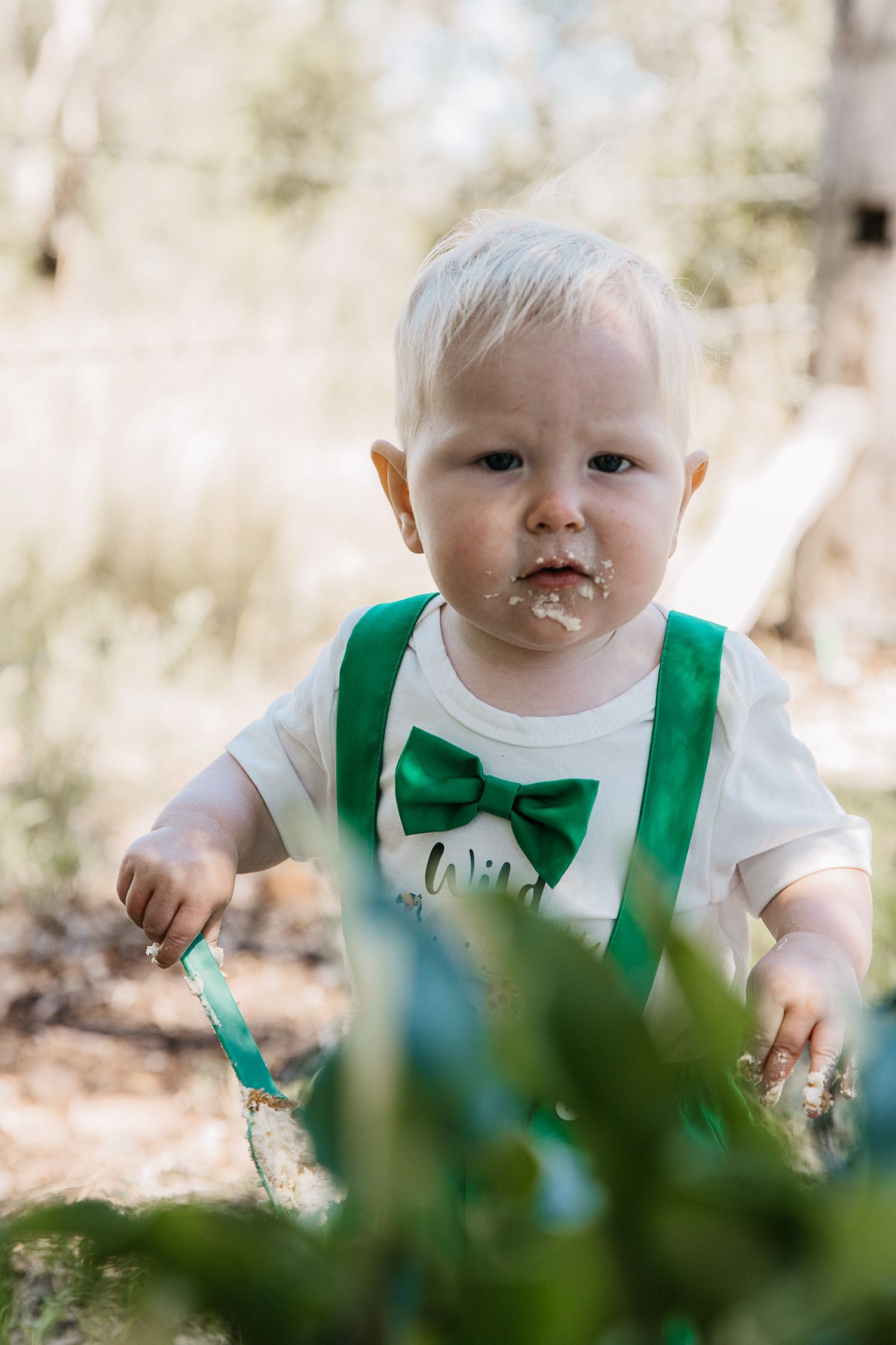 Baby boy walking around at a "Wild One" professional cake smash photo shoot
