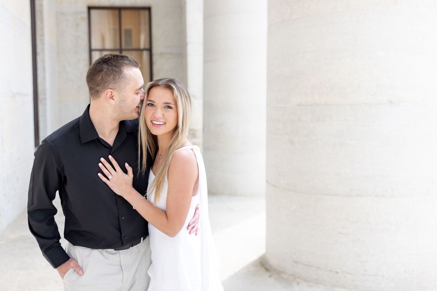 Light and airy engagement photos of a joyful couple at the Ohio Statehouse in downtown Columbus, Ohio captured by Julia and Sean Photography