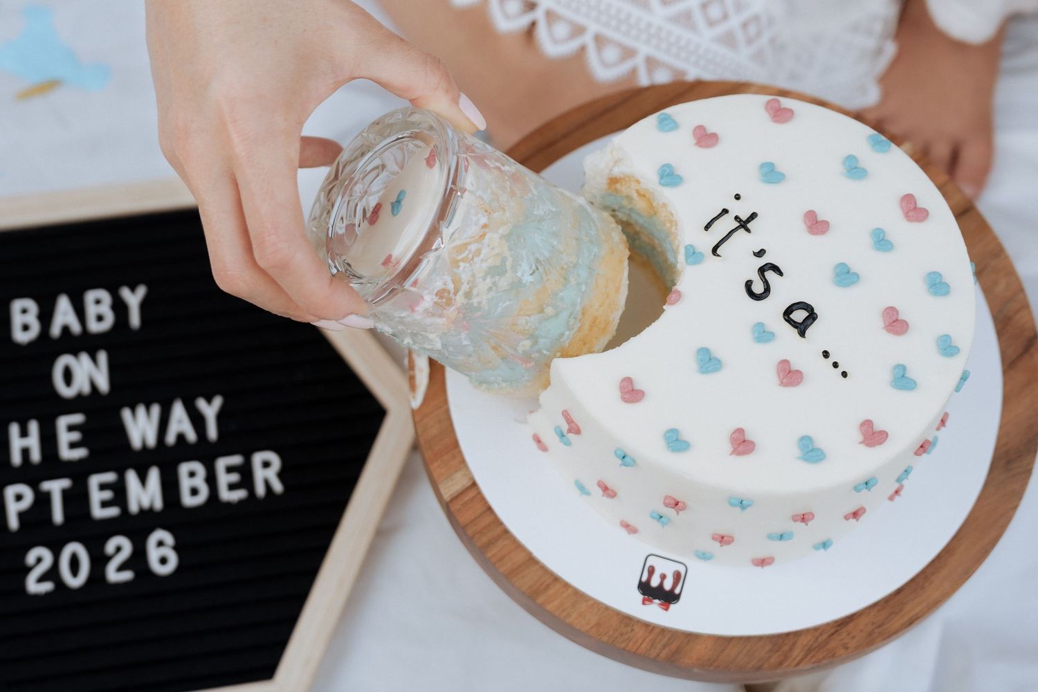 Baby announcement cake during maternity photoshoot Dubai with soft pastel styling