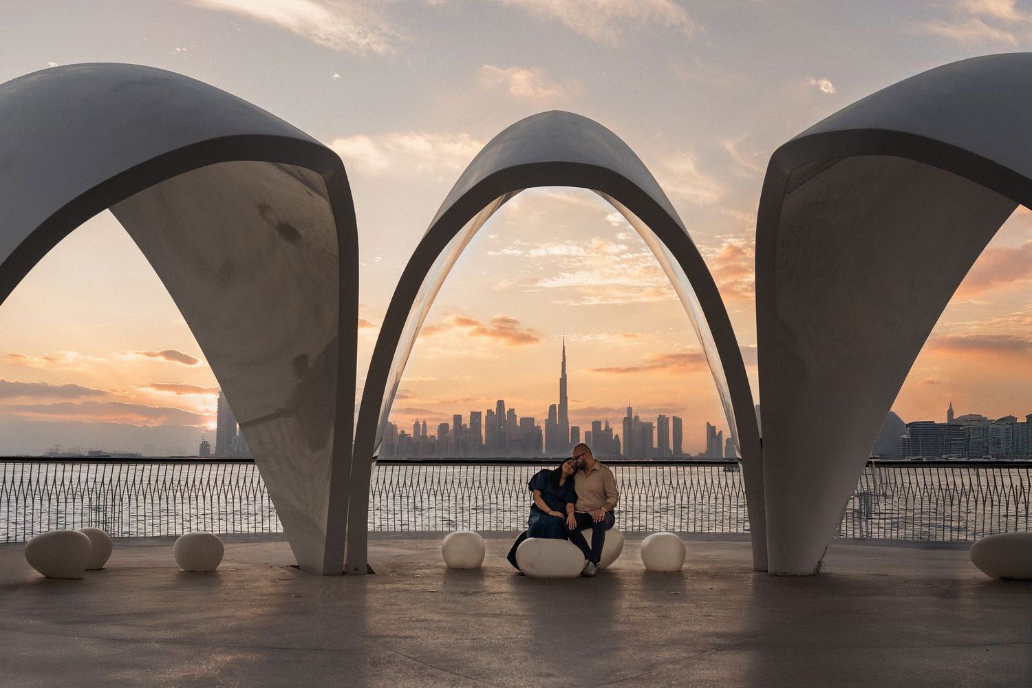 Maternity photoshoot in Dubai at sunset with couple in romantic architectural setting