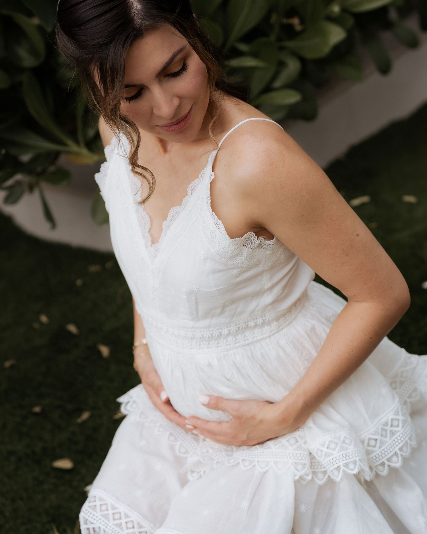 Elegant maternity portrait in Dubai with mother-to-be in white dress outdoors