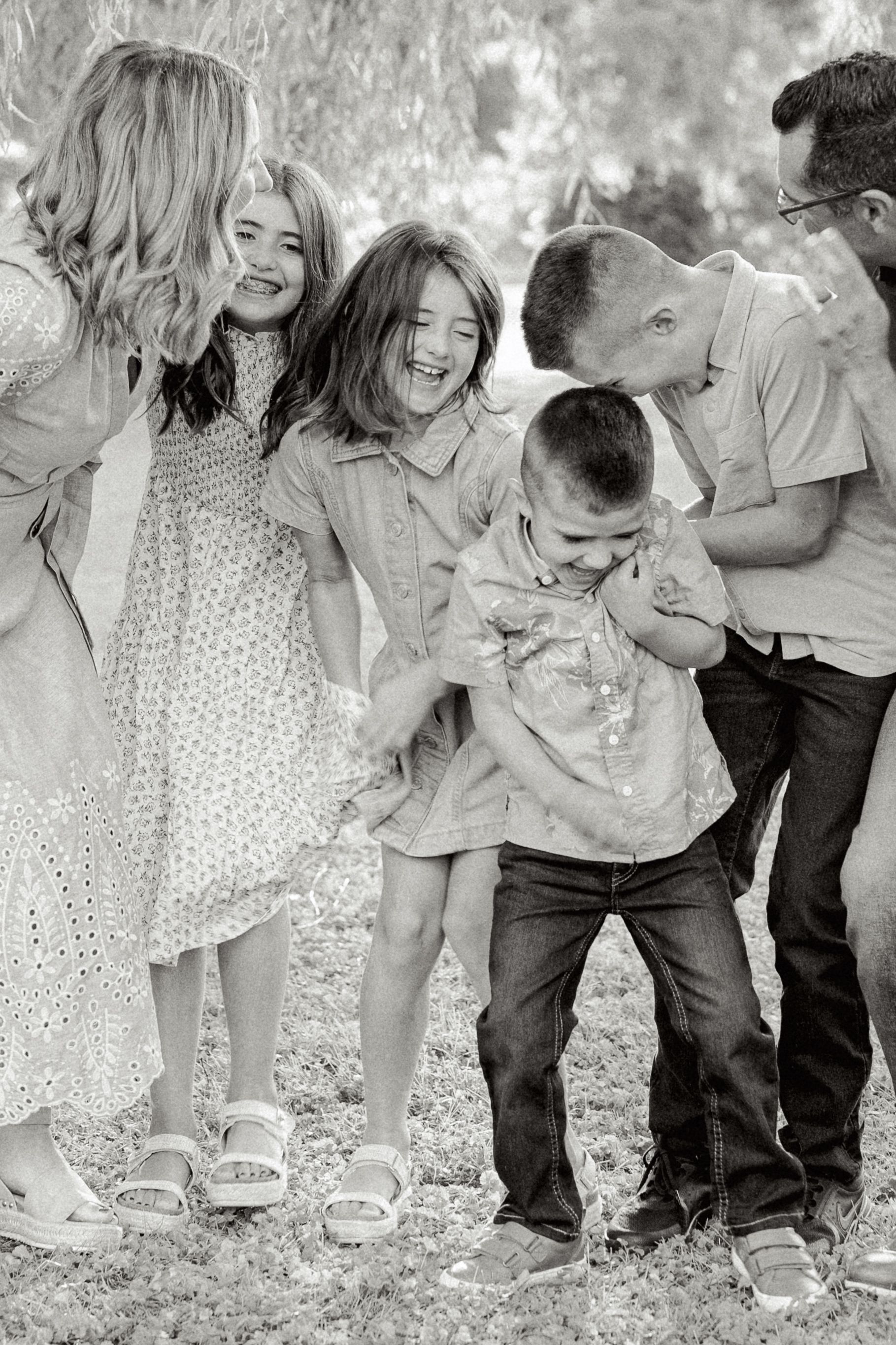 Black and white candid photos show joyful moments between people in casual attire outdoors.