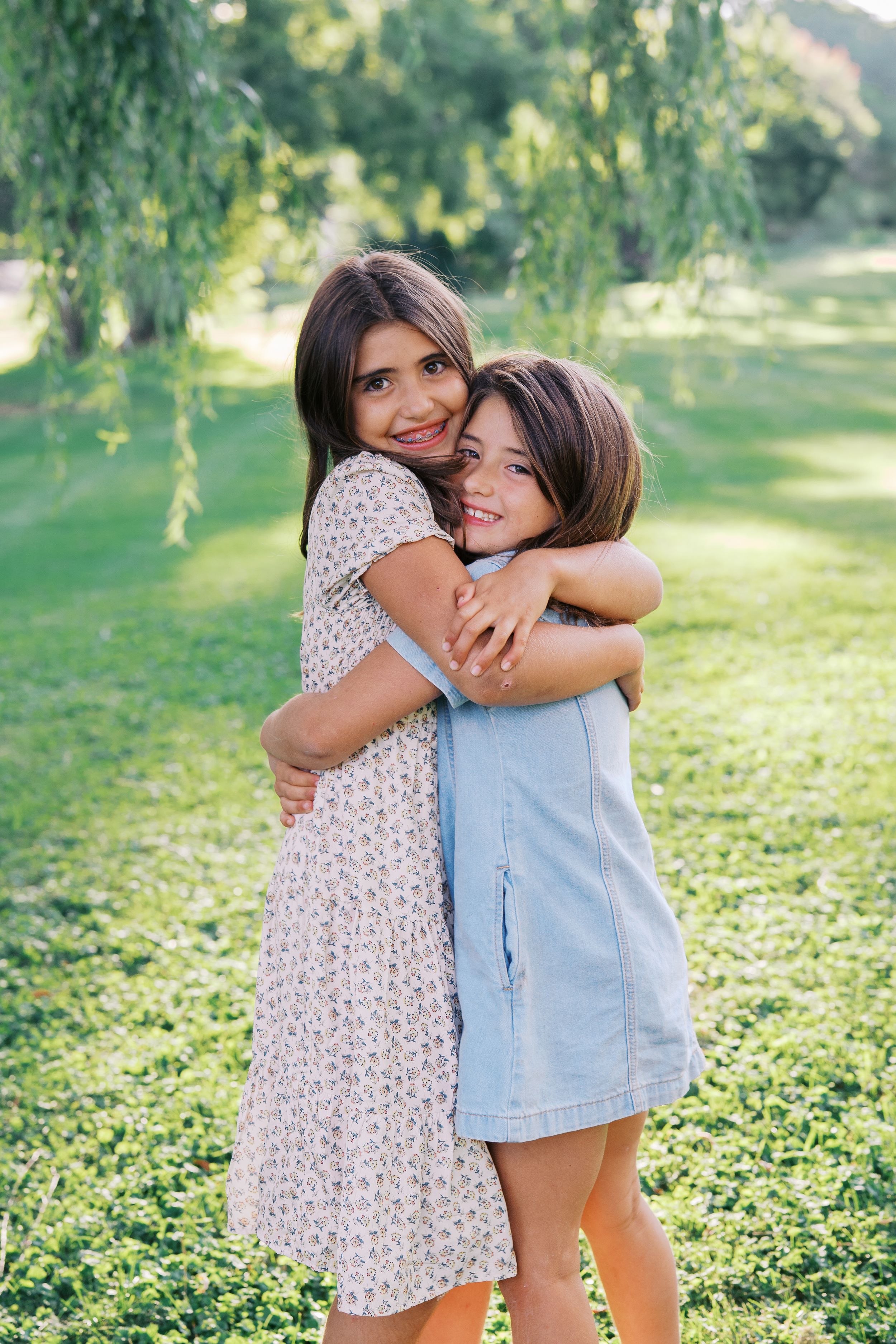 Siblings sharing a playful embrace while enjoying a summer day outdoors.
