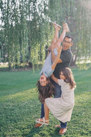 A sequence of playful swinging motions captured under drooping willow branches.