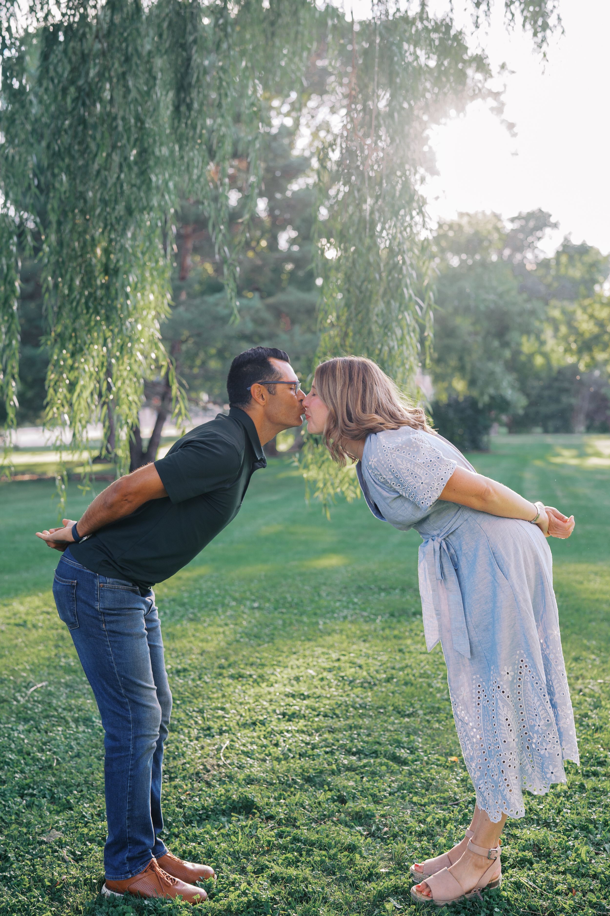 A romantic series of photos capturing a tender moment between two people beneath a willow tree at sunset.