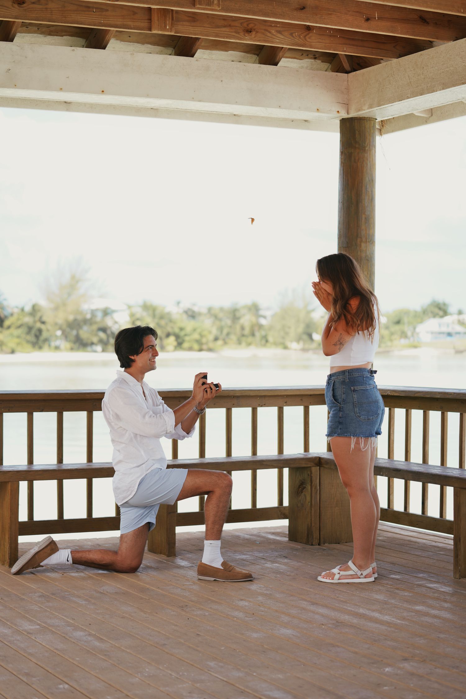 Engagement proposal photo in Spanish Wells cabana with turquoise water in the background