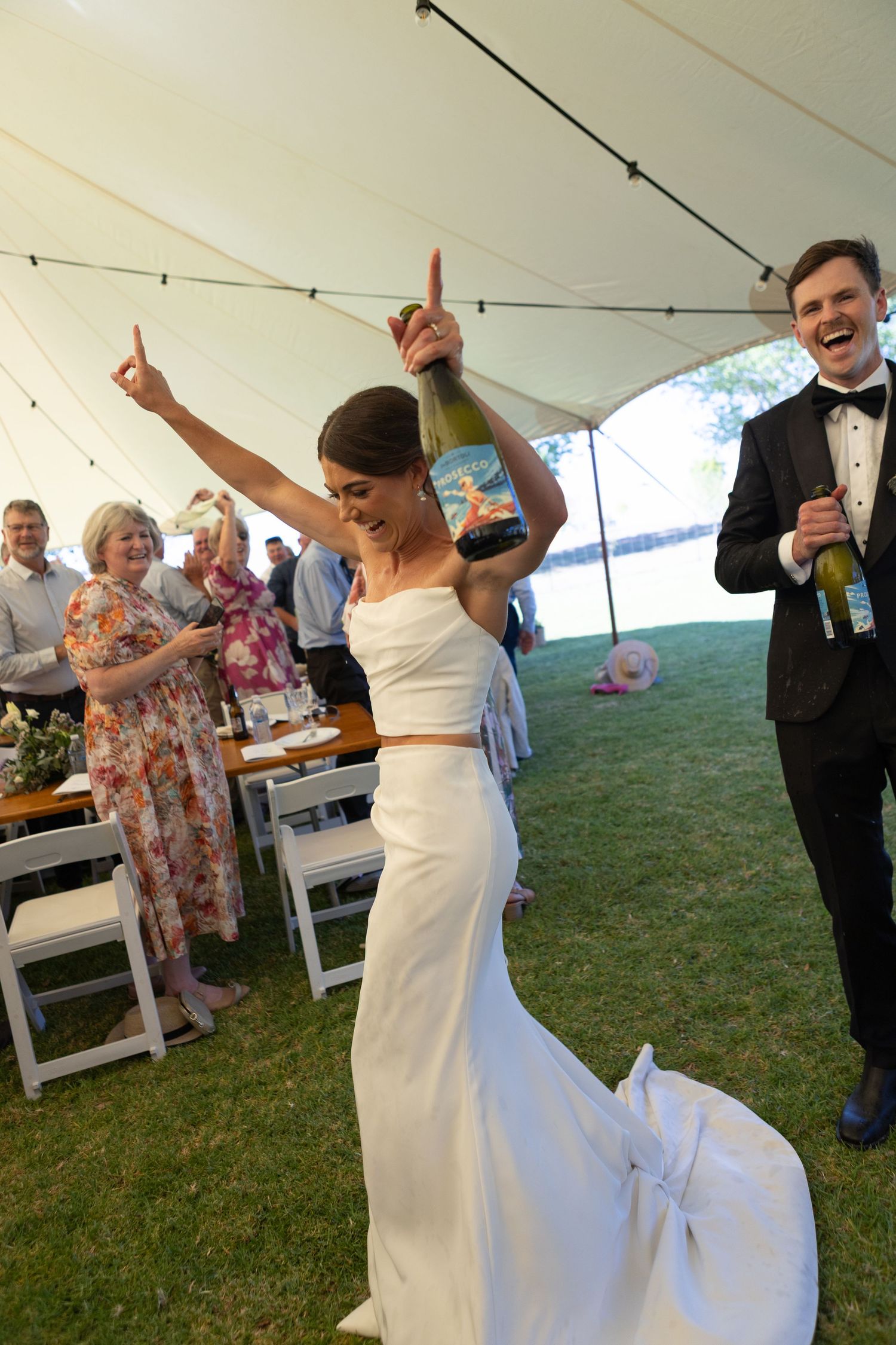 Bride and groom entering marquee at their reception of country wedding