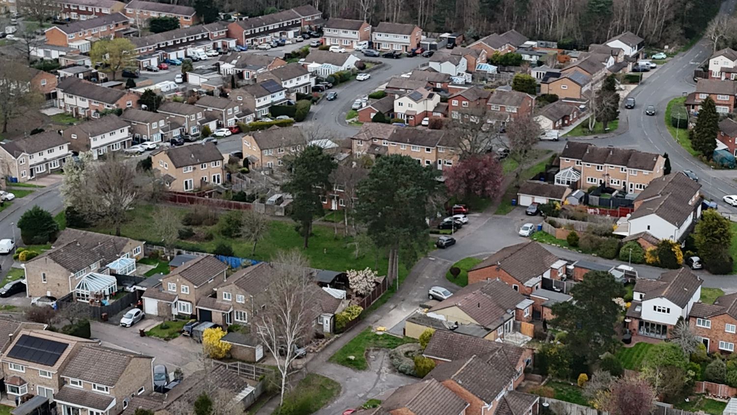 Aerial panoramic view of residential suburban neighborhood with houses and streets during winter season.