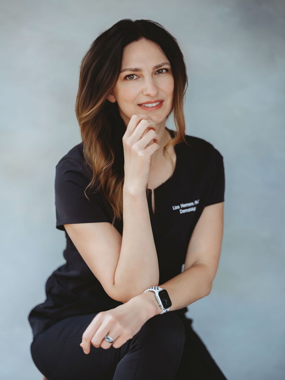 Studio portraits featuring casual poses in black t-shirt against light gray background.