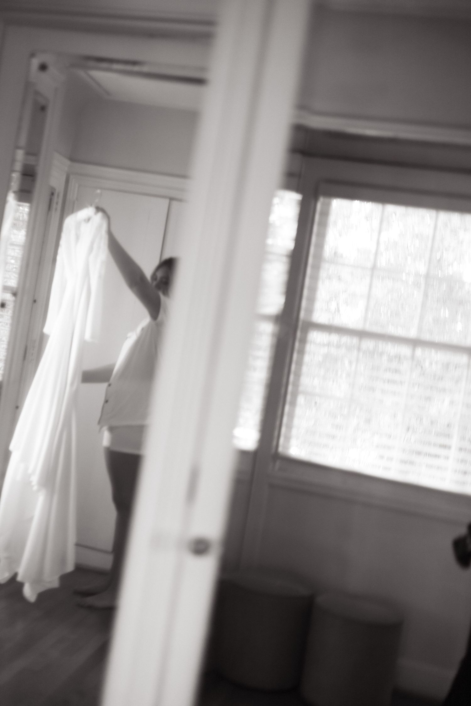 A moving shadow figure in white appears to dance across a bright minimalist interior space.
