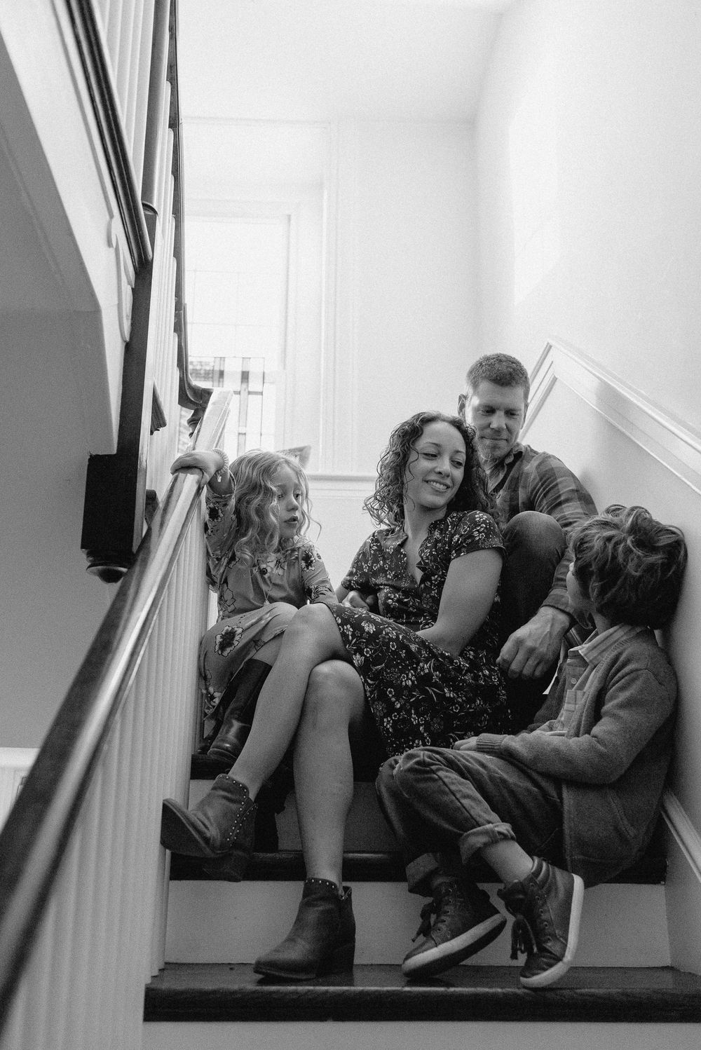 An intimate family portrait session captured on white interior stairs.