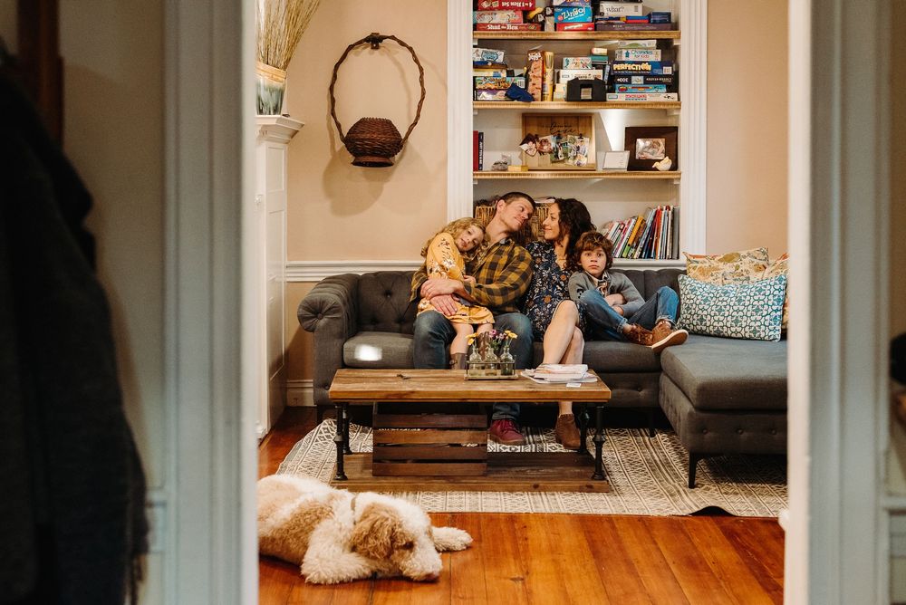 A cozy living room scene with a sectional sofa, coffee table, and built-in bookshelves.