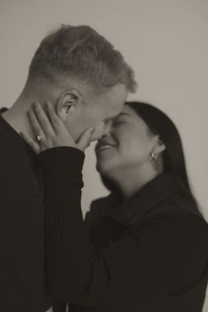 An artistic black and white portrait capturing genuine laughter between a couple.
