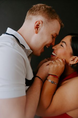 Close-up of a couple sharing tender moments with genuine smiles and laughter.