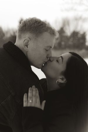 A romantic black and white photo sequence of a couple sharing an intimate kiss in winter.