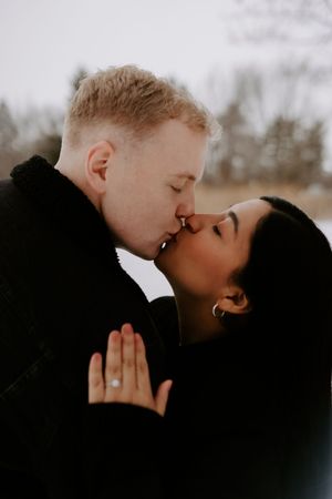 A romantic winter portrait capturing an intimate moment between a couple.
