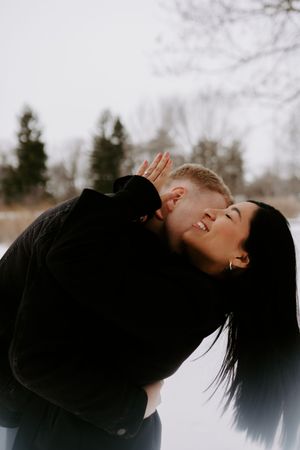 Artistic series showing a couple embracing and kissing against a snowy winter backdrop.