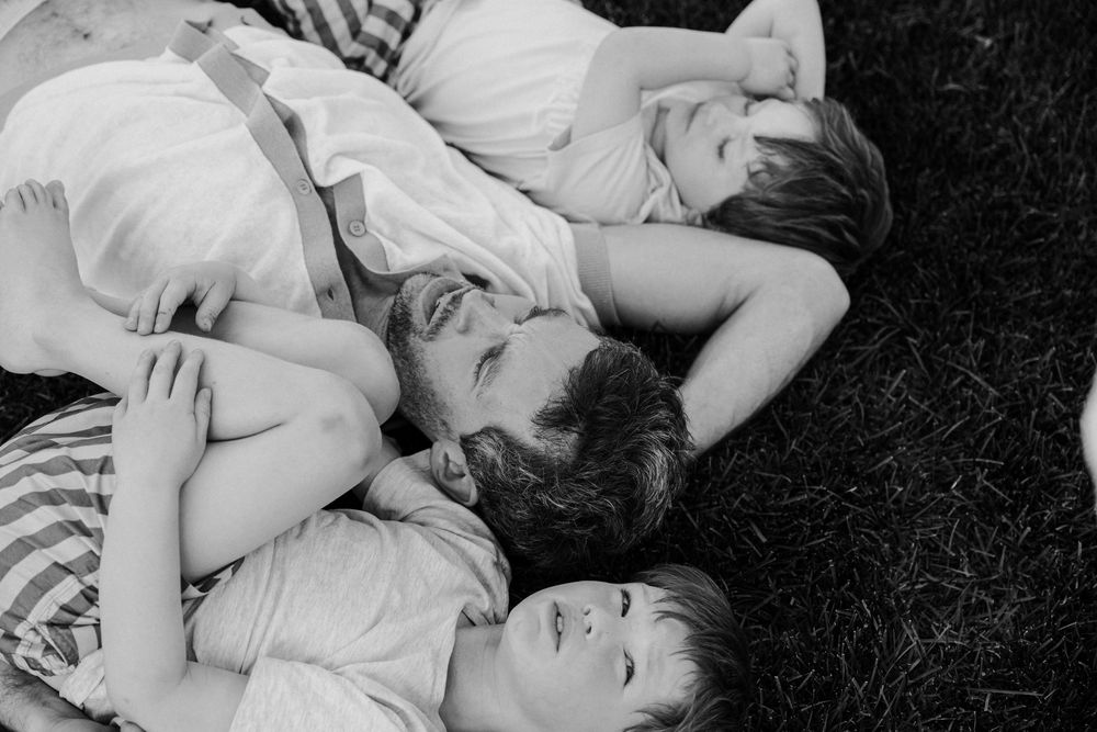 Black and white photo series shows two people in intimate embraces with natural lighting and soft composition.