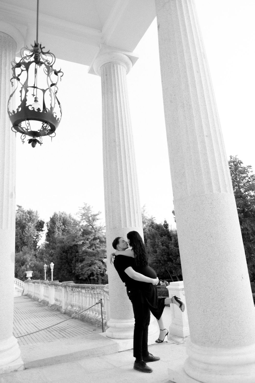 At a white columned porch, a couple dances together in black and white through multiple connecting frames.