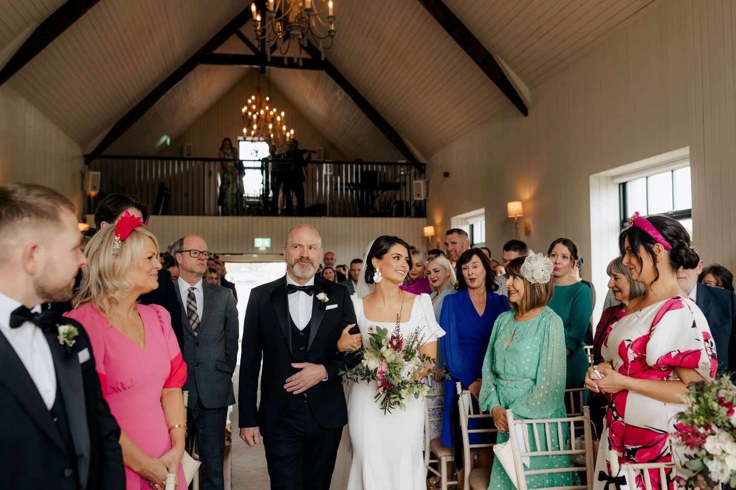 Wedding ceremony inside a chapel with guests gathered to celebrate.