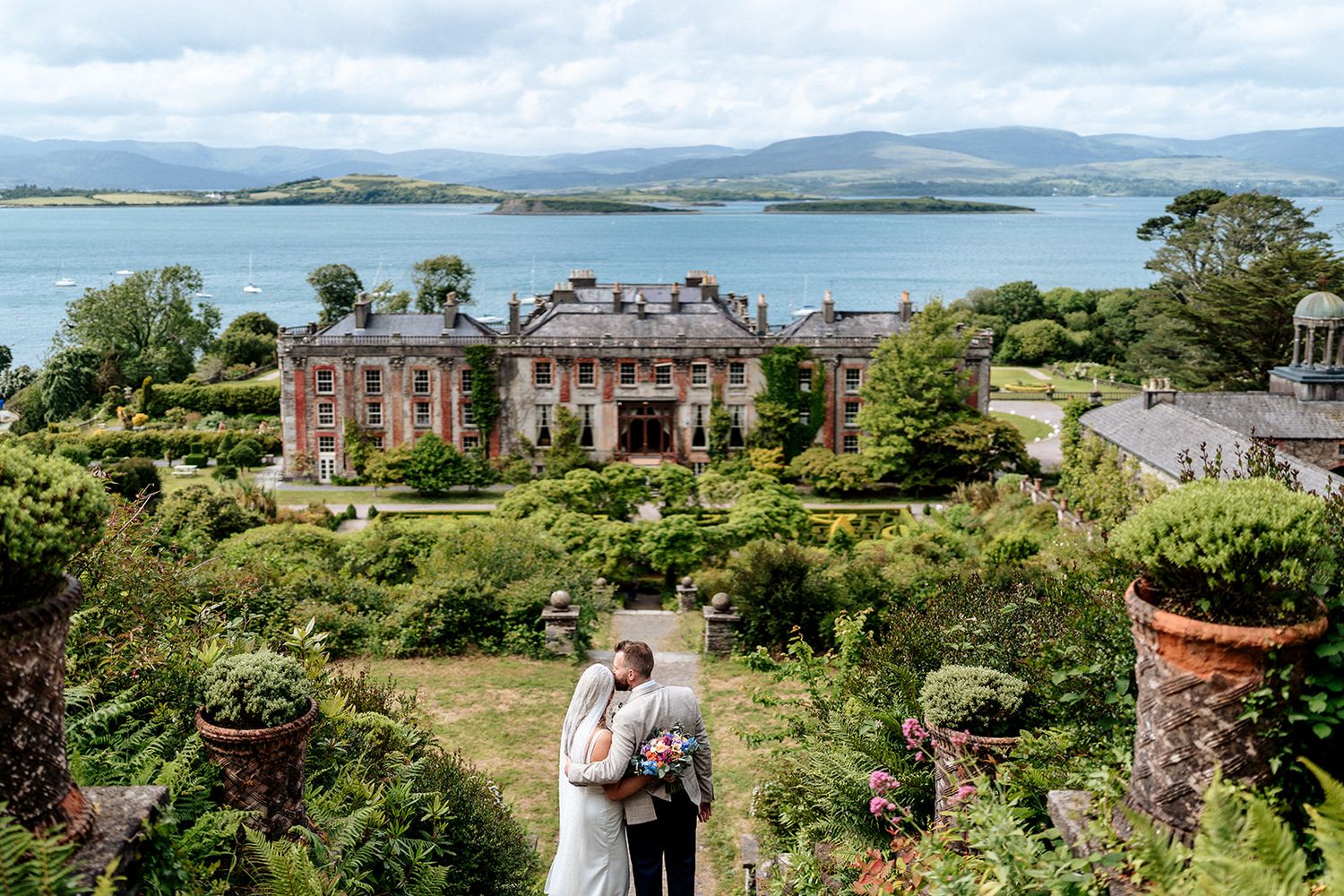 A luxury wedding venue in Ireland showcases scenic coastal views and lush gardens surrounding an elegant historic manor house.